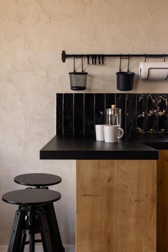 a kitchen with two stools and a counter top at Widok Paleśnica in Paleśnica
