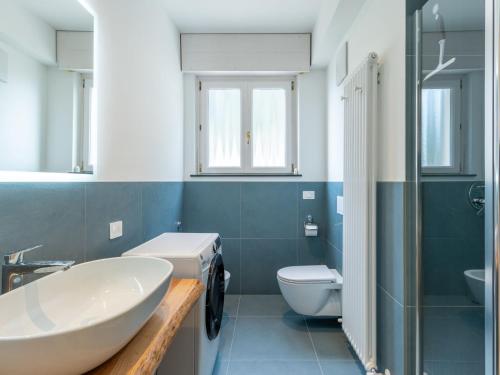 a bathroom with a white sink and a toilet at Apartment Lago di Luce by Interhome in Riva del Garda