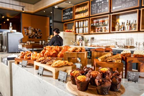 a bakery with many different types of bread on display at ibis Cambridge Central Station in Cambridge
