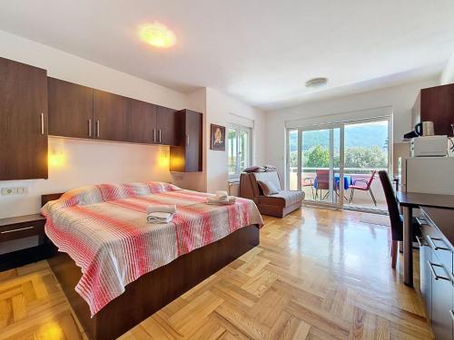 a bedroom with a bed and a kitchen and a living room at Studio Rilić-1 by Interhome in Zaostrog