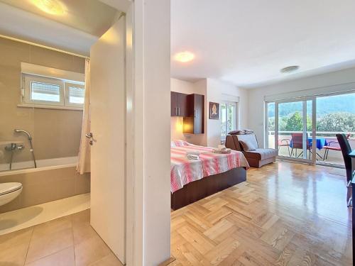 a bedroom with a bed and a bath room at Studio Rilić-1 by Interhome in Zaostrog