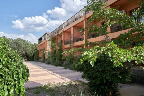 a building with plants growing on the side of it at Avenue Park Hotel in Yusufkhona