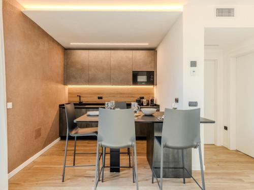 a kitchen and dining room with a table and chairs at Apartment Garda Oasis by Interhome in Riva del Garda