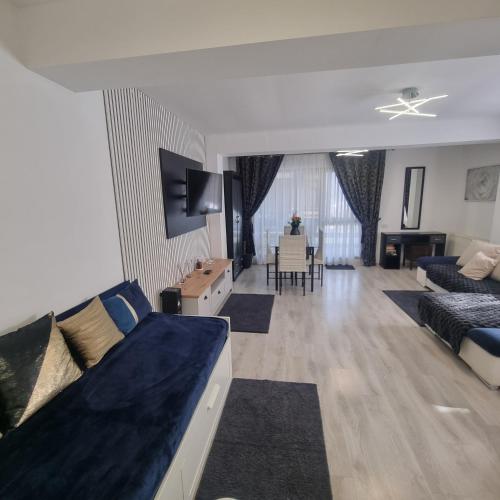 a living room with a couch and a dining room at Apartament Kalinderu K3 Busteni in Buşteni