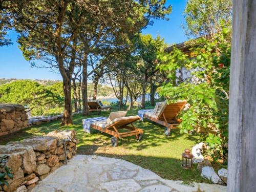 a backyard with a patio furniture and a dog at Apartment Vista 9 by Interhome in Porto Cervo