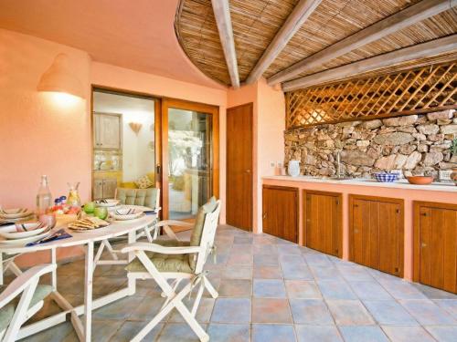 a kitchen and dining room with a table and chairs at Apartment Vista 9 by Interhome in Porto Cervo
