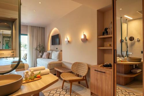 a bathroom with a bed and a sink in a room at Zeus Eleva Kassandra Lagoon in Hanioti