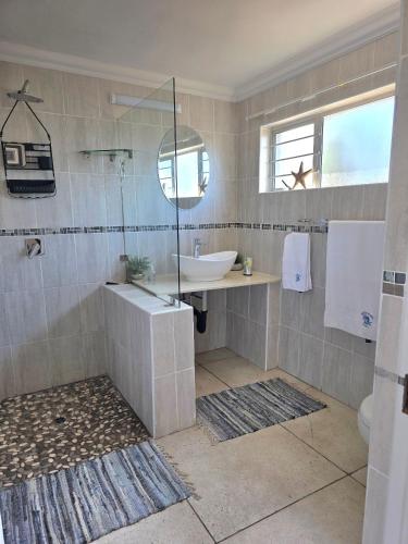 a bathroom with a shower and a sink and a tub at Miskin Place Unit 2 in Kelso