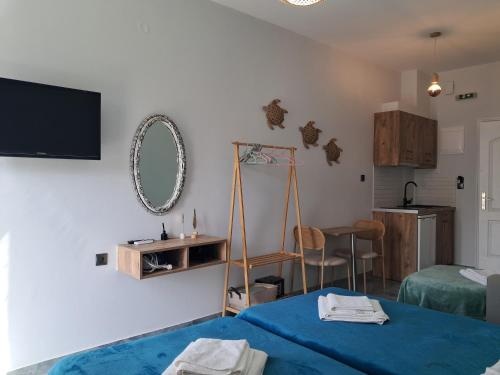 a room with a bed and a mirror on the wall at Poppy Beloni in Chania