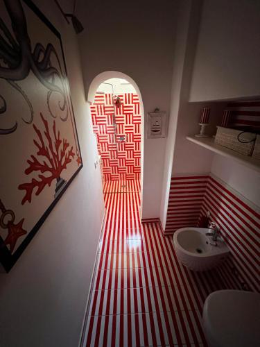 a bathroom with a red and whitestriped floor at Villa Croce Anacapri in Anacapri