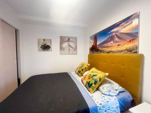 a bedroom with a bed and pictures on the wall at playa honda sky view in Playa de las Americas