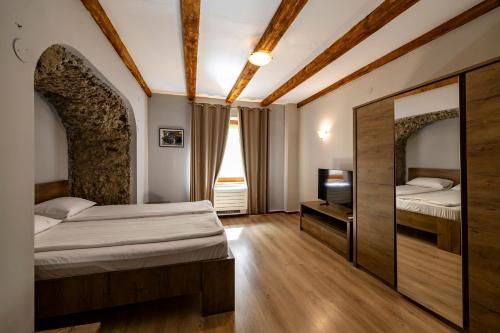 a hotel room with two beds and a television at Arsenal Park Transilvania in Orăştie