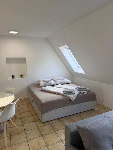 a white bedroom with a bed and a window at Ankerplatz Drakenburgi in Drakenburg