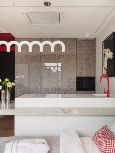 a bathroom with a glass shower in a room at Scarlet Jacuzzi Suit by Sofija in Warsaw
