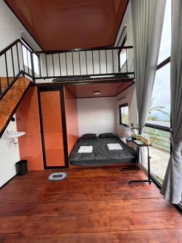 a bedroom with a bunk bed in a house at Krincing Hills Cabin in Kalijoso