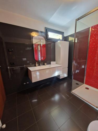 a bathroom with a sink and a shower at Luxury casa Margherita in Pianello Del Lario