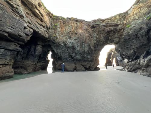 a cave in a rock wall on the beach at Casal de pelaio in Barreiros