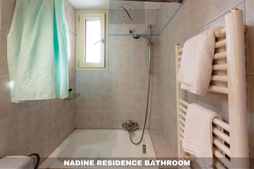 a bathroom with a bath tub and a shower at Epavlis Nadine Corfu in Corfu