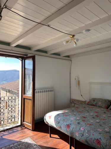 a bedroom with a bed and a large window at Civico 15 in Antrosano