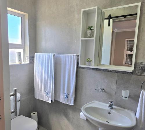 a bathroom with a sink and a toilet and a mirror at Miskin Place Unit 3 in Pennington