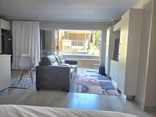 a living room with a couch and a television at Miskin Place Unit 3 in Pennington