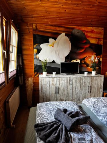 a bedroom with a bed in a wooden cabin at Ferienwohnung“puutalossa“ in Sehlen