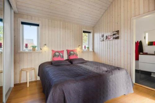 a bedroom with a large bed with pink pillows at K19082-Kalundborg-Sandlodsvej-18 in Asnæs