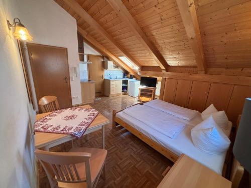 a small room with a bed and a table at Appartementhaus Marion in Bad Bayersoien