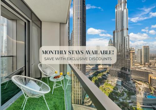 a balcony with chairs and a view of the city at SmartStay at Grande Signature - Burj Khalifa View - 5 min Dubai Mall - Downtown Dubai - Brand New Luxury Apartments in Dubai