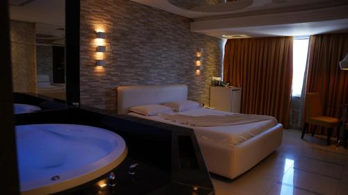 a hotel room with a bed and a sink at Altana Motel in Brasília