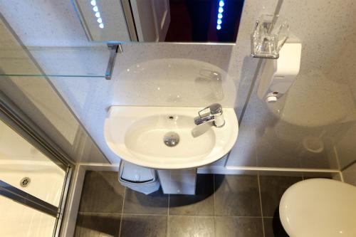 a bathroom with a sink and a toilet at Regent House Hotel - City Centre Hotel in Edinburgh