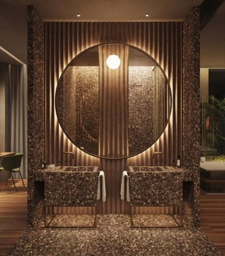 a lobby with a large mirror and two chairs at The Bank by MYR Hotels in Valencia