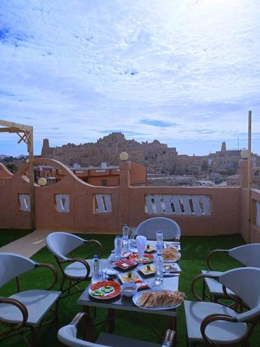 a table with plates of food on a roof at Al-BARNY HOTEL in Siwa