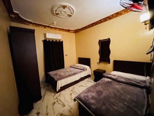 a bedroom with two beds and a ceiling at Al-BARNY HOTEL in Siwa