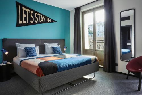 a bedroom with a bed with a sign that says lets stay in at The Social Hub Madrid 4 star in Madrid