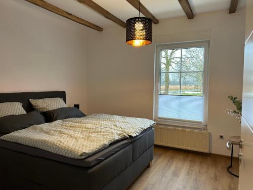 a bedroom with a bed and a window at Landidyll Georg in Ostbevern