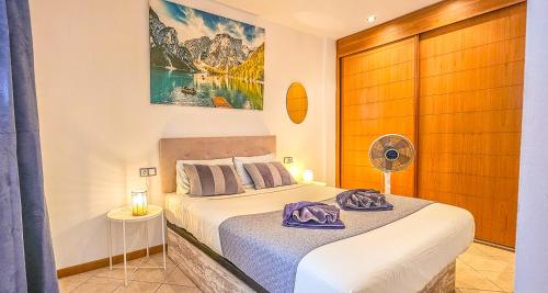 a bedroom with a bed with a fan on it at Adeje Paradise dreams in Playa Paraiso