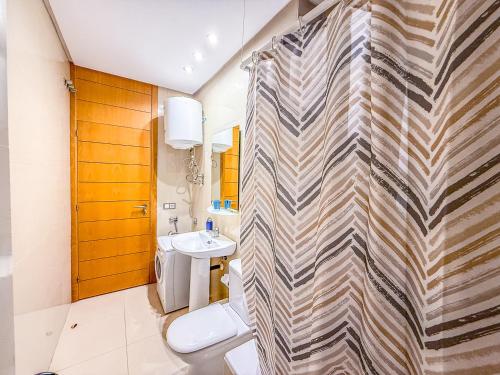 a bathroom with a toilet and a sink at Adeje Paradise dreams in Playa Paraiso
