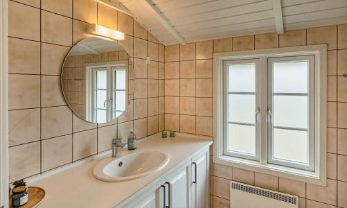 a bathroom with a sink and a mirror at VE134-Vejers-Strand-Jafdalvej-89 in Vejers Strand