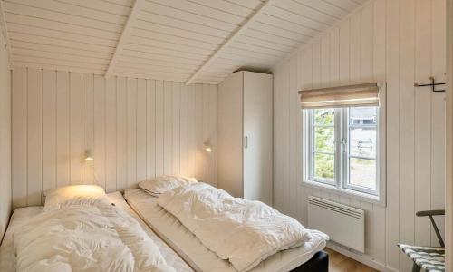 a bed in a room with a window at VE134-Vejers-Strand-Jafdalvej-89 in Vejers Strand