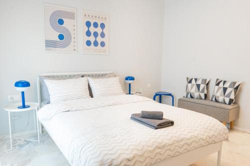 a bedroom with a large bed and a chair at Blue Studio in Xanthi