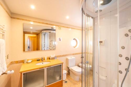 a bathroom with a sink and a toilet and a shower at Villa dos Teixos in Cascais