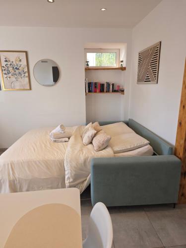 En eller flere senge i et værelse på Appartement Les Géraniums