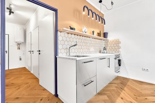 a kitchen with white cabinets and a sink at O'Hara in Horní Blatná