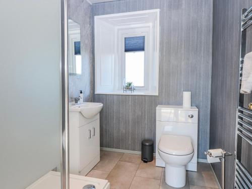 a bathroom with a white toilet and a sink at Little Norwood in Perth