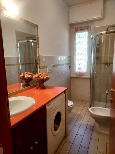 a bathroom with a sink and a washing machine at Casa di Doria in Deiva Marina
