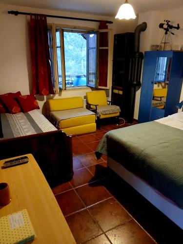 a bedroom with two beds and a table and a desk at Vila Eva in Međuvršje