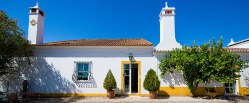 a white building with a tower on top of it at Monte da Japonica in Redondo