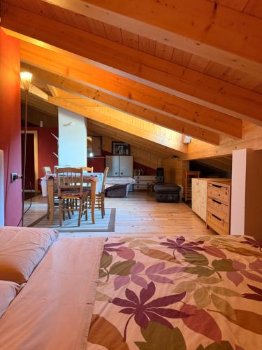a large room with a bed and a dining room at Mansarda Il Castello in Ossana