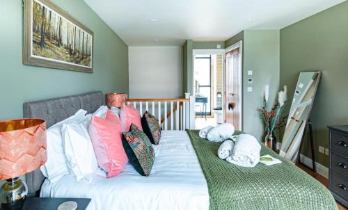 a bedroom with a bed with pillows on it at The Sanctuary in Stow on the Wold